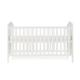 White Cot Bed with base on its new born setting, sides rails have teething rails, ends finished with curved tops 