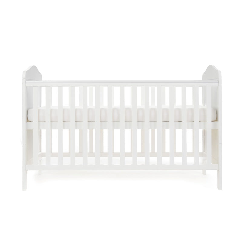 White Cot Bed with base on its new born setting, sides rails have teething rails, ends finished with curved tops 