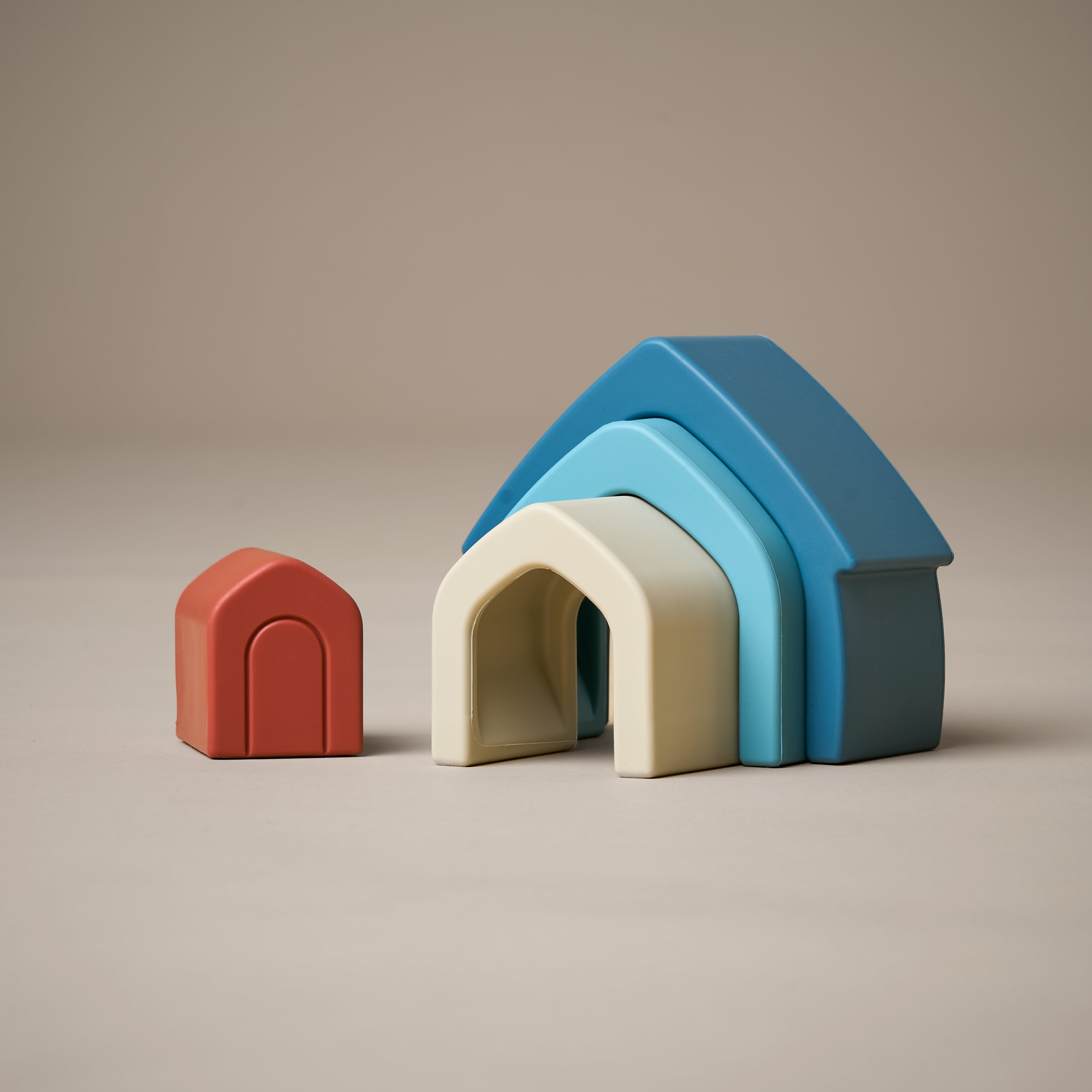 Unstacked stacking house toy in orange, natural and blue colours