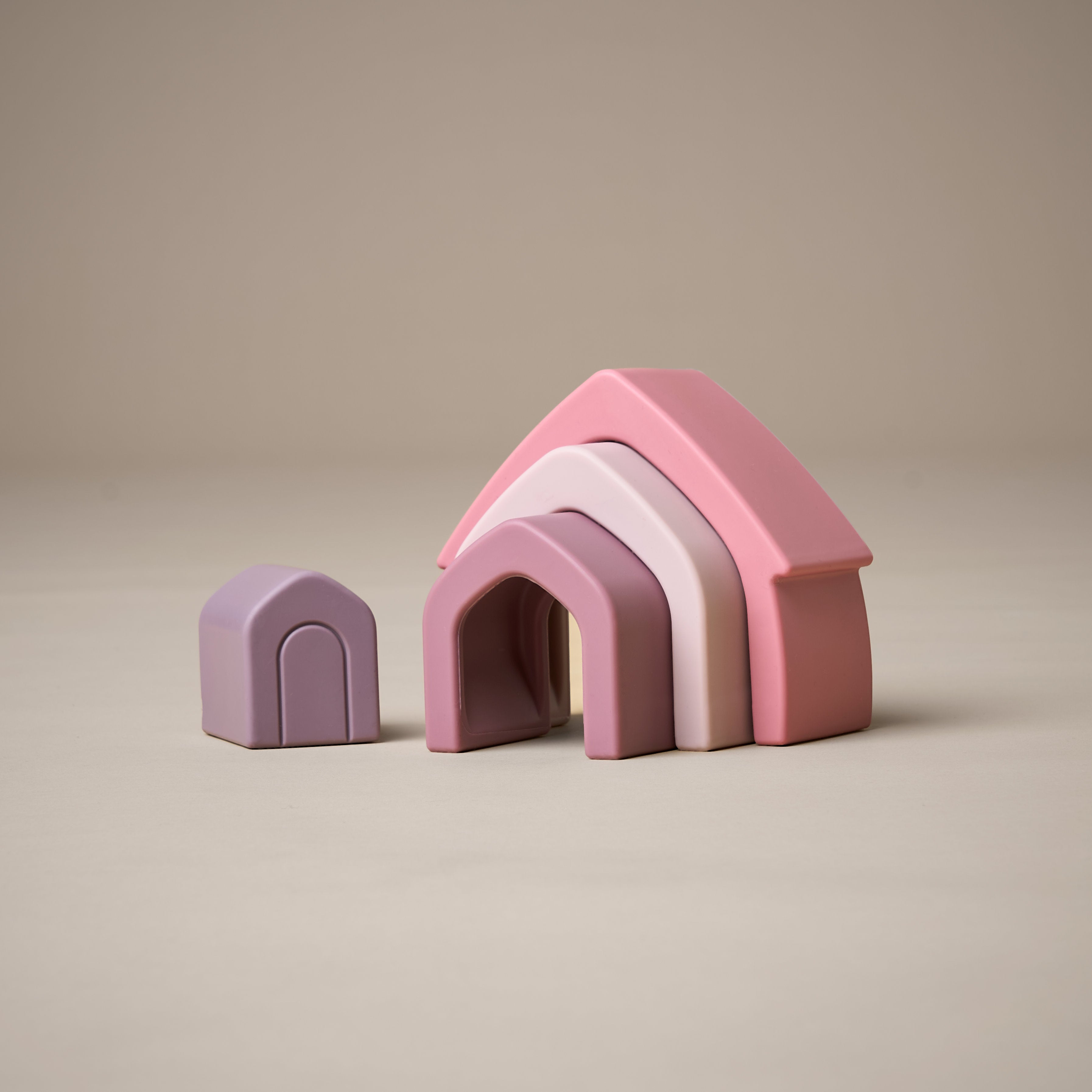 Unstacked stacking house toy in purple and pink colours