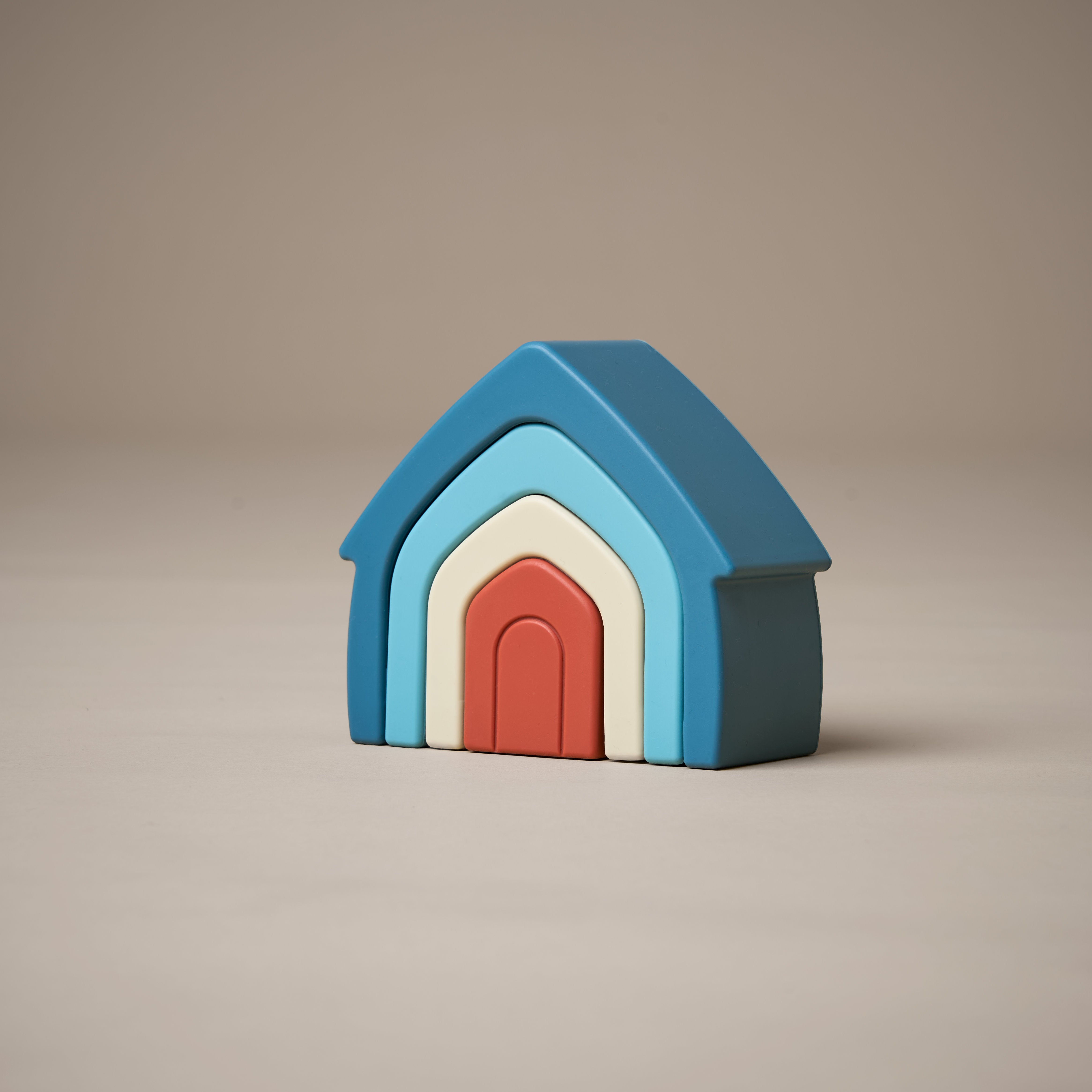 Stacked stacking house toy in orange, natural and blue colours