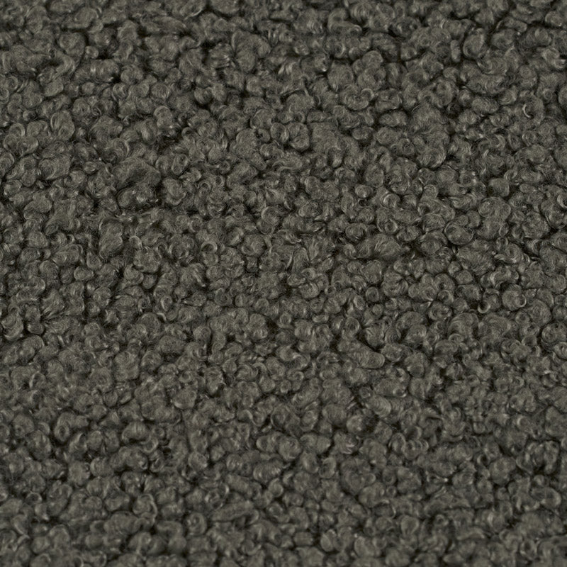 Close up of soft teddy fabric in dark green, olive tones 